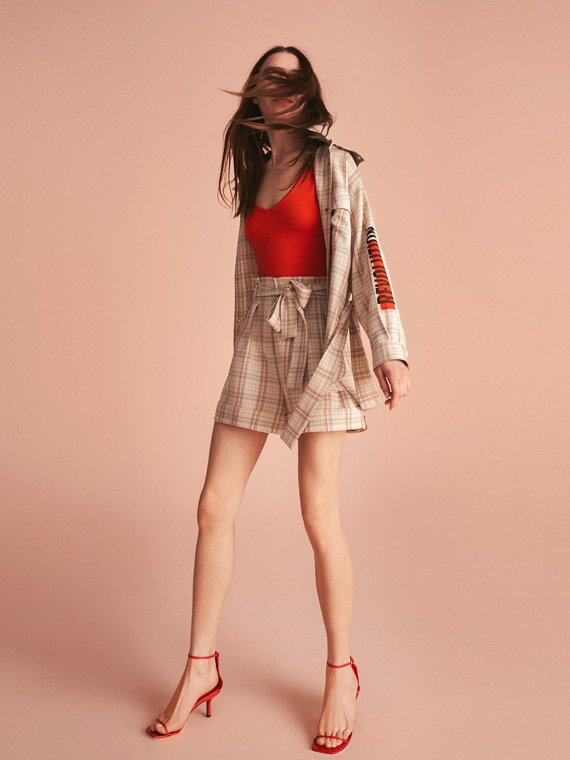 Belted plaid shorts featuring a wide fit, side pockets, and a tied self belt in vibrant colors.