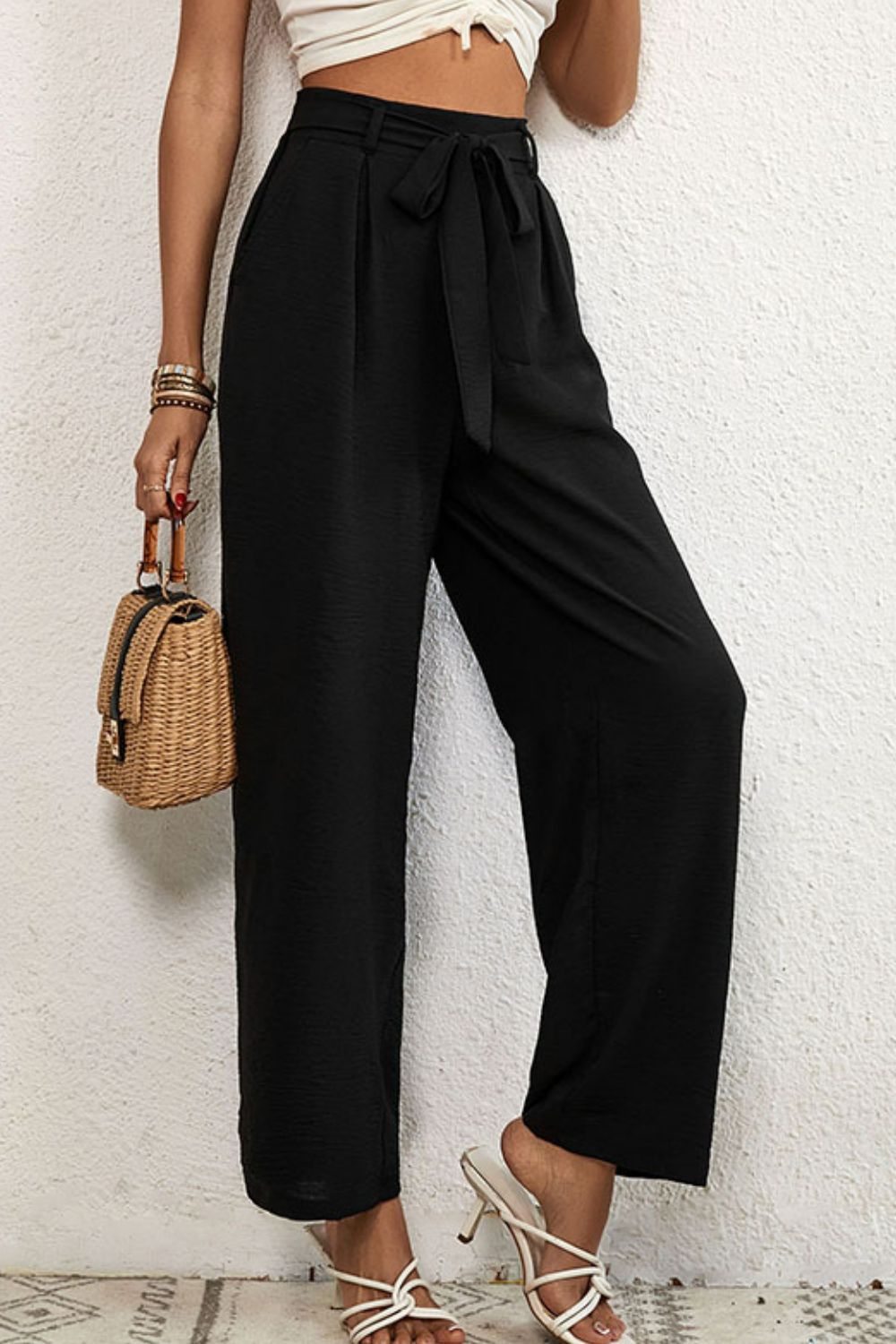 Belted pleated waist wide leg pants in a solid color, showcasing a minimalist design with a stylish belt.