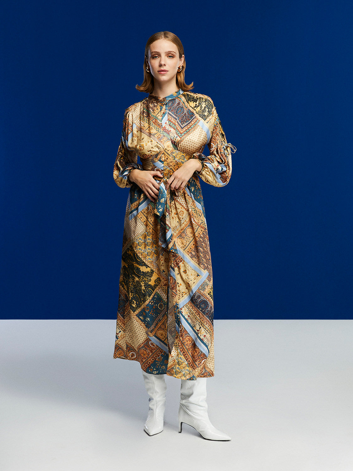 A stylish long-sleeved belted print dress in toasty brown with a Mandarin collar and side slits, perfect for winter wear.