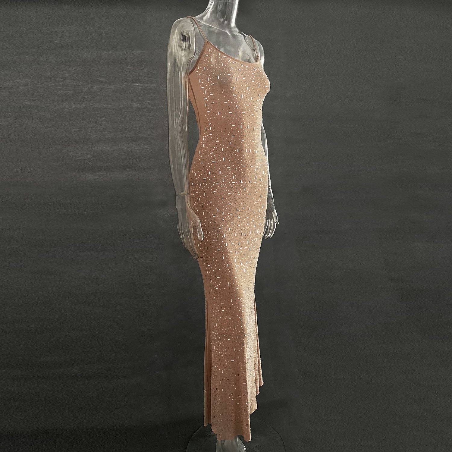 A stunning light diamond sexy sling mermaid dress featuring rhinestone embellishments and a sleeveless spaghetti strap design, perfect for formal occasions.