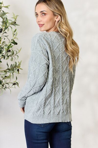 BiBi Cable Knit Round Neck Sweater in a cozy design, showcasing intricate cable knit patterns and a comfortable fit.