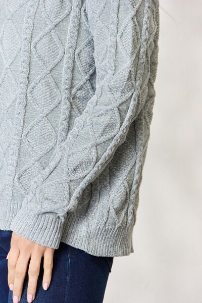 BiBi Cable Knit Round Neck Sweater in a cozy design, showcasing intricate cable knit patterns and a comfortable fit.