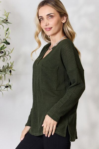 BiBi Notched Popcorn Waffle Long Sleeve Top in a cozy popcorn knit with a front pocket, showcasing its relaxed style and comfortable fit.