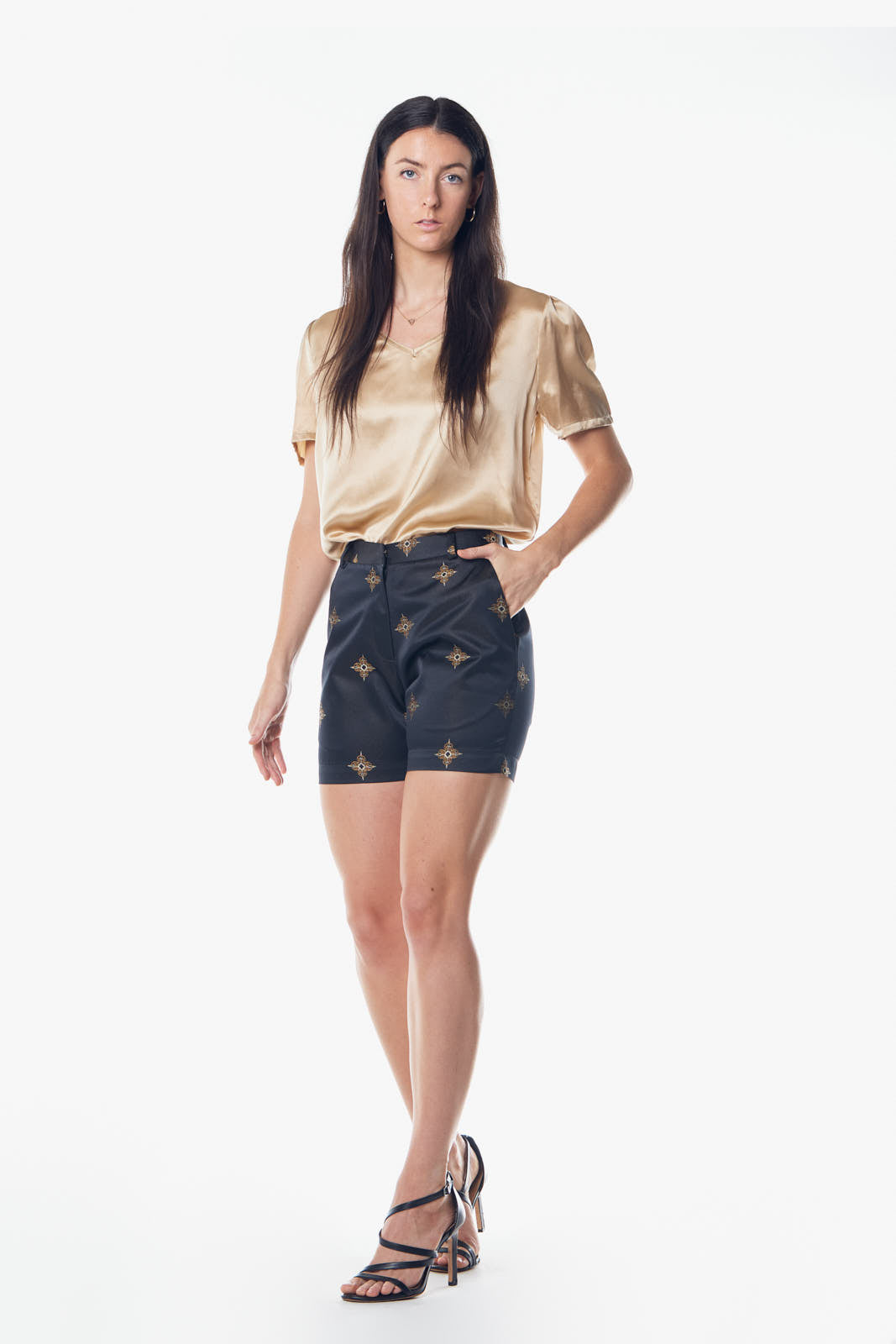 Luxury black and gold shorts from Le Reussi, showcasing elegant design and high-quality fabric.