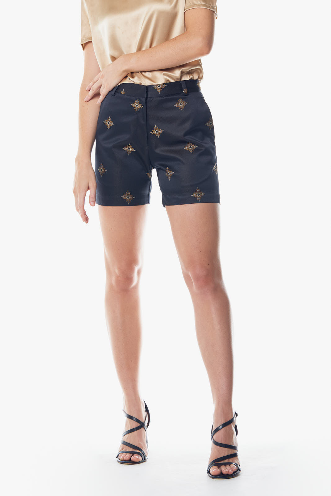 Luxury black and gold shorts from Le Reussi, showcasing elegant design and high-quality fabric.