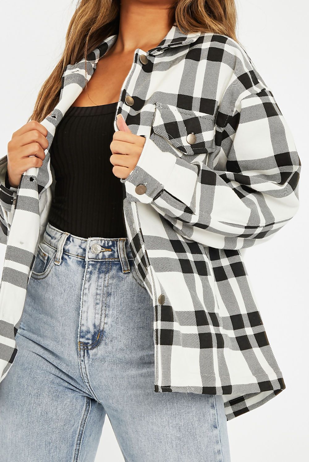 A stylish Black and White Check Shacket for women, featuring an oversized fit, button front, and two chest pockets.