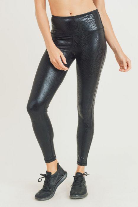 Black highwaist leggings featuring a unique Nagini snake foil print, designed for comfort and style with a sleek obsidian finish.