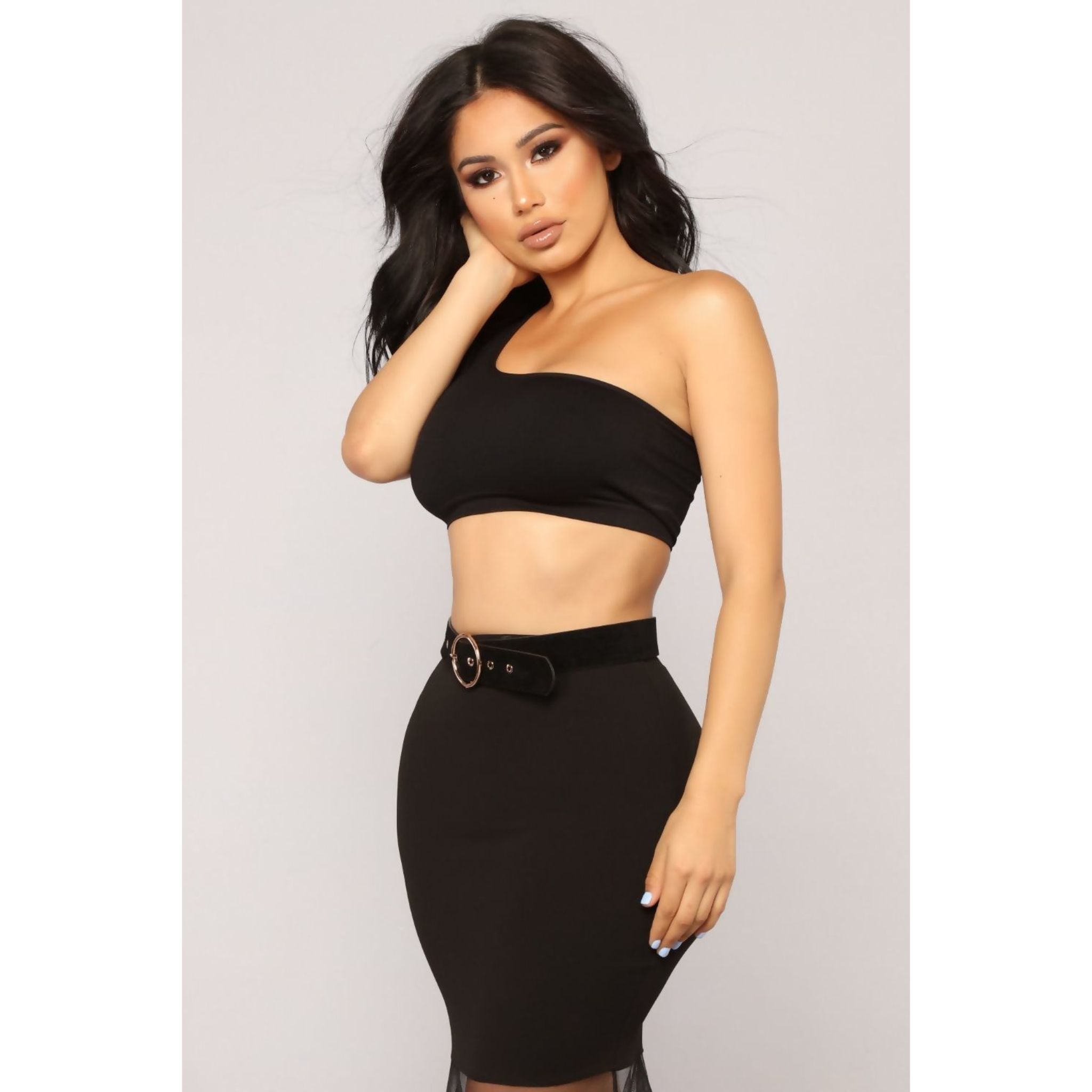 A stylish black one shoulder crop top made from a soft polyester blend, perfect for casual or dressy occasions.