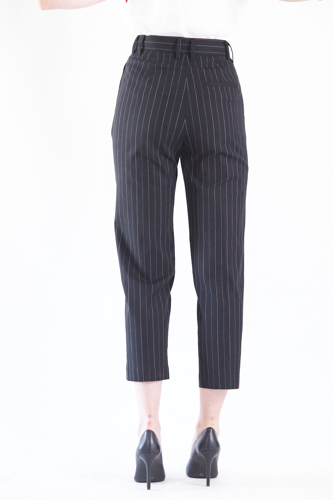 Black pinstripes suit pants with a high-rise waist and slim-straight leg, featuring white stripes on a black background.