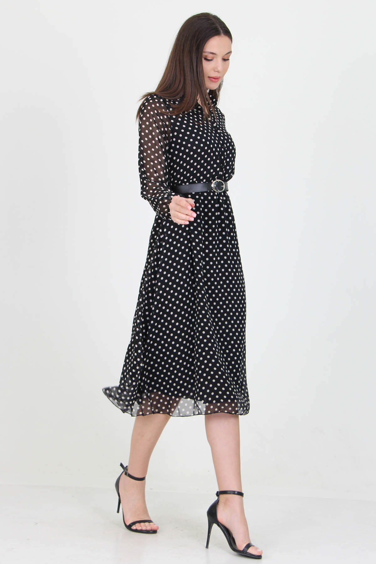 A stylish black dress adorned with white polka dots, perfect for various occasions.