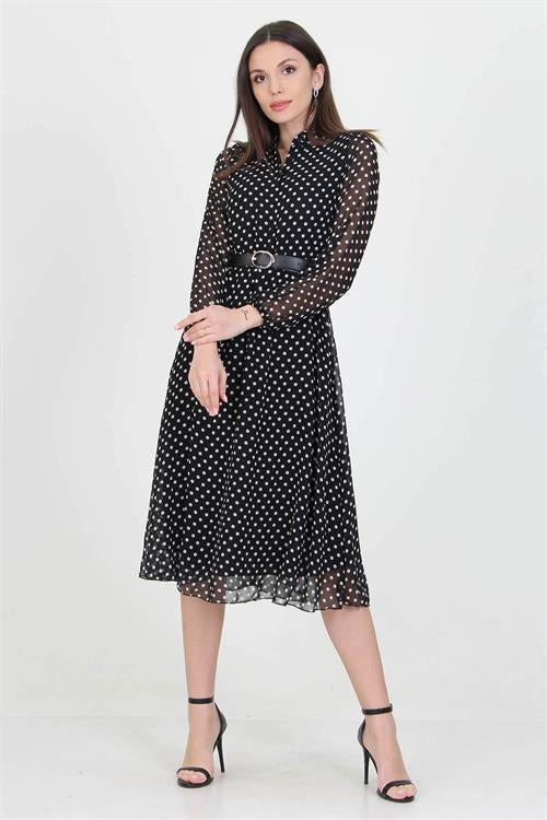 A stylish black dress adorned with white polka dots, perfect for various occasions.