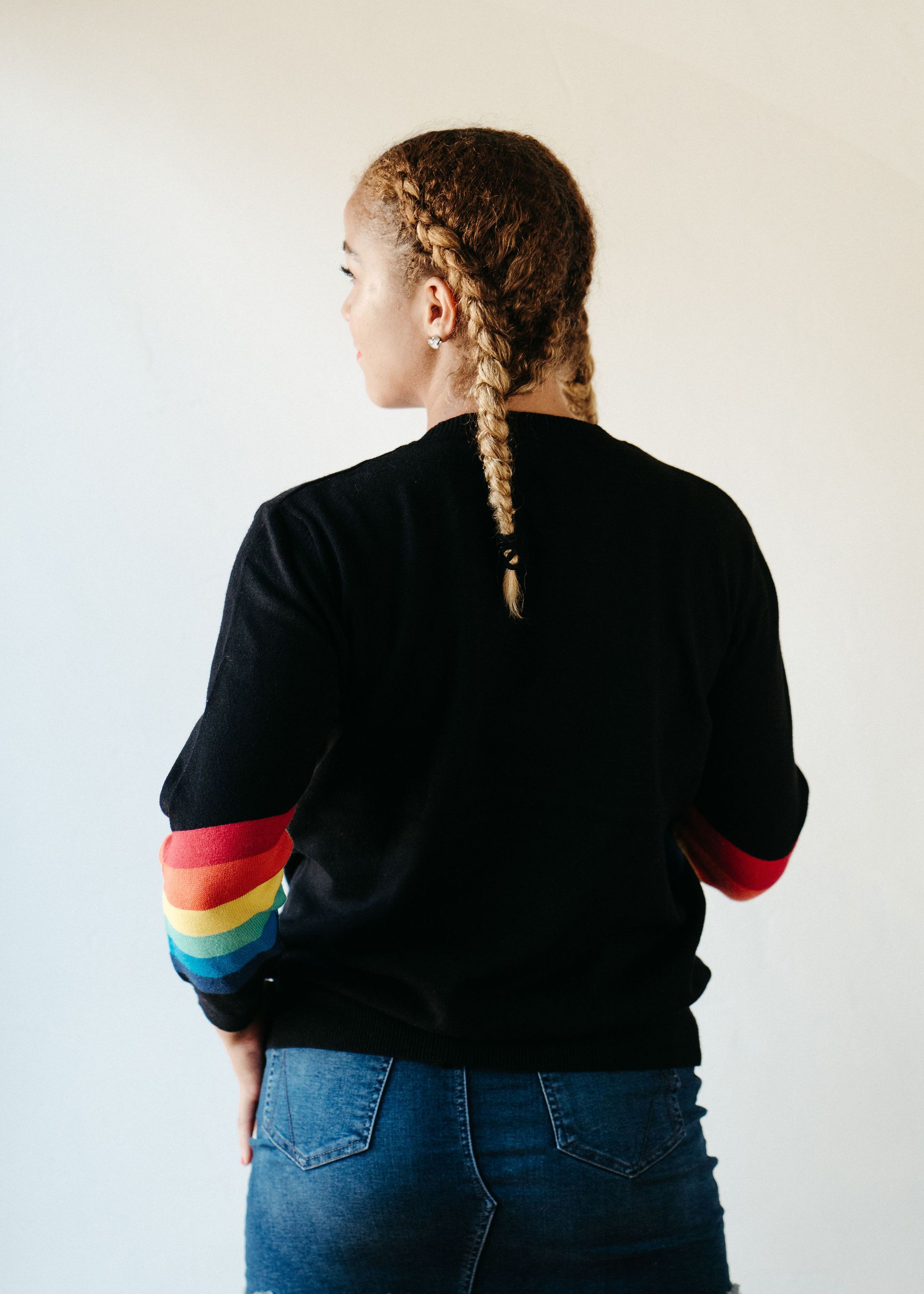 A stylish Black Rainbow Sweater featuring a soft fabric blend, perfect for winter layering and casual outings.