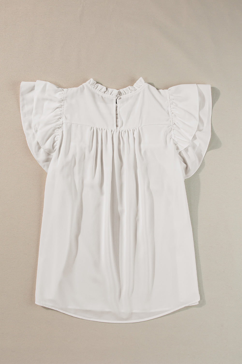 Black smocked ruffle sleeve blouse displayed on a mannequin, showcasing its elegant design and feminine details.