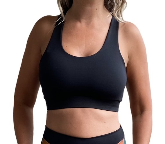 Black sports bra featuring fanned crossed back straps and scoop neck design, perfect for yoga and gym workouts.