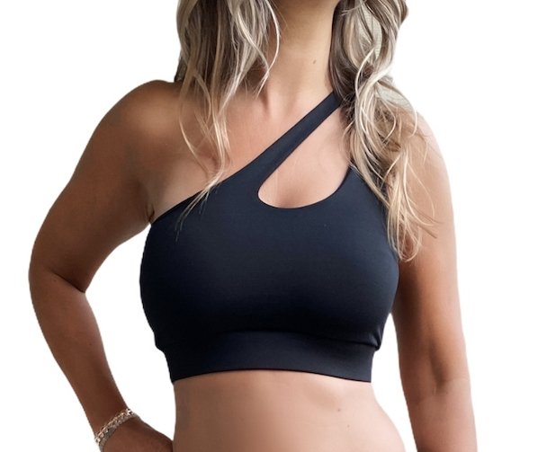 Black one shoulder sports bra with a stylish cut-out design, featuring a wide chest band for support.