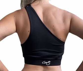 Black one shoulder sports bra with a stylish cut-out design, featuring a wide chest band for support.