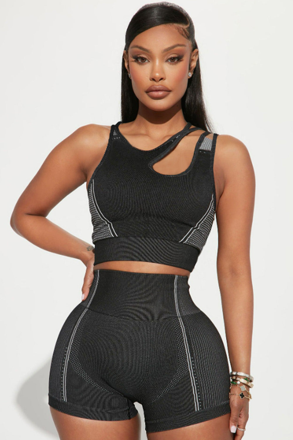 Black strappy mix pattern cutout bra and high-waist shorts set, showcasing stylish design and supportive features for active wear.