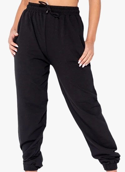 Black oversized joggers with a tie waist, featuring front pockets and a relaxed fit, perfect for casual wear.