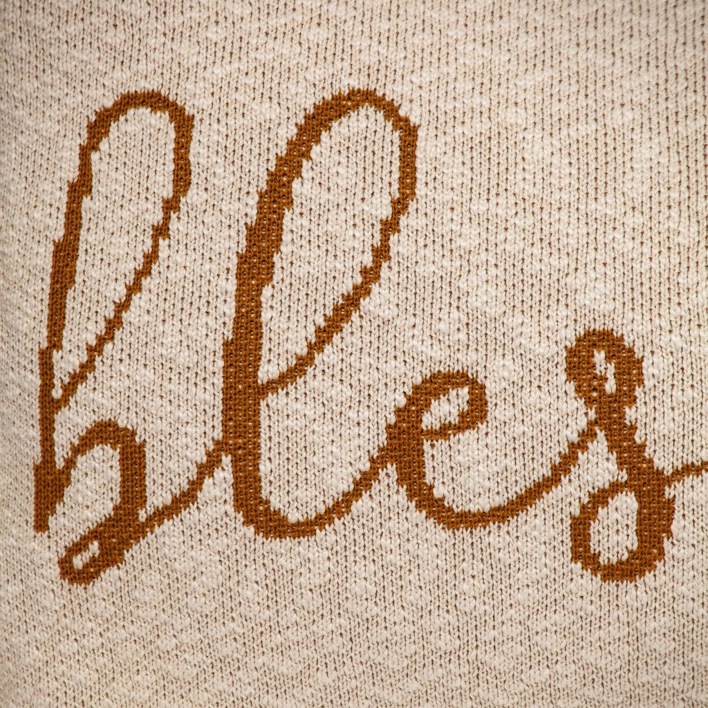 Blessed Carmel Throw Pillow with cream backdrop and caramel cursive text, perfect for home decor.