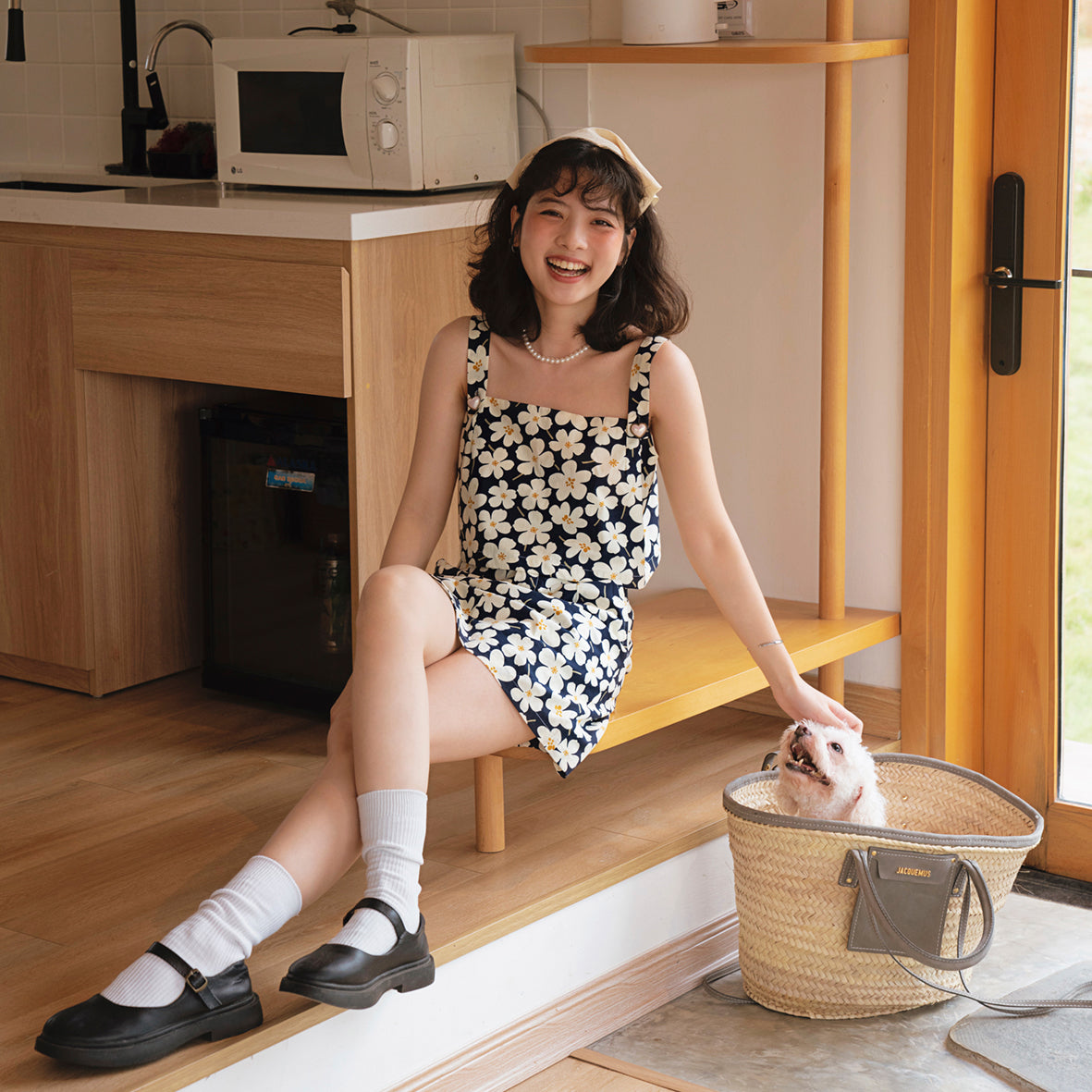 A stylish Blooming Skort featuring floral motifs, soft silk lining, and decorative heart button straps, perfect for warm weather.