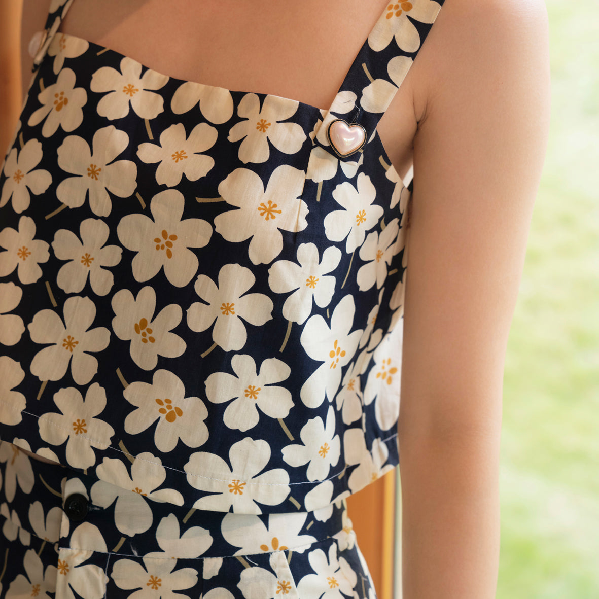 Blooming Top set featuring floral motifs, cotton fabric, and decorative heart buttons, displayed elegantly on a mannequin.