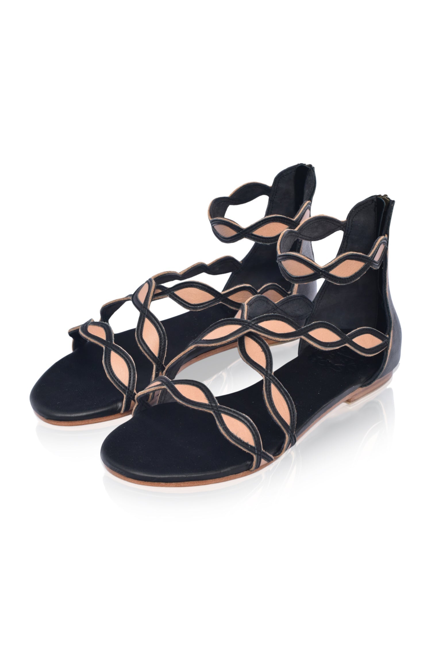 A pair of Blossom Leather Sandals featuring a floral design, crafted from high-quality leather with an adjustable ankle buckle and back zipper.