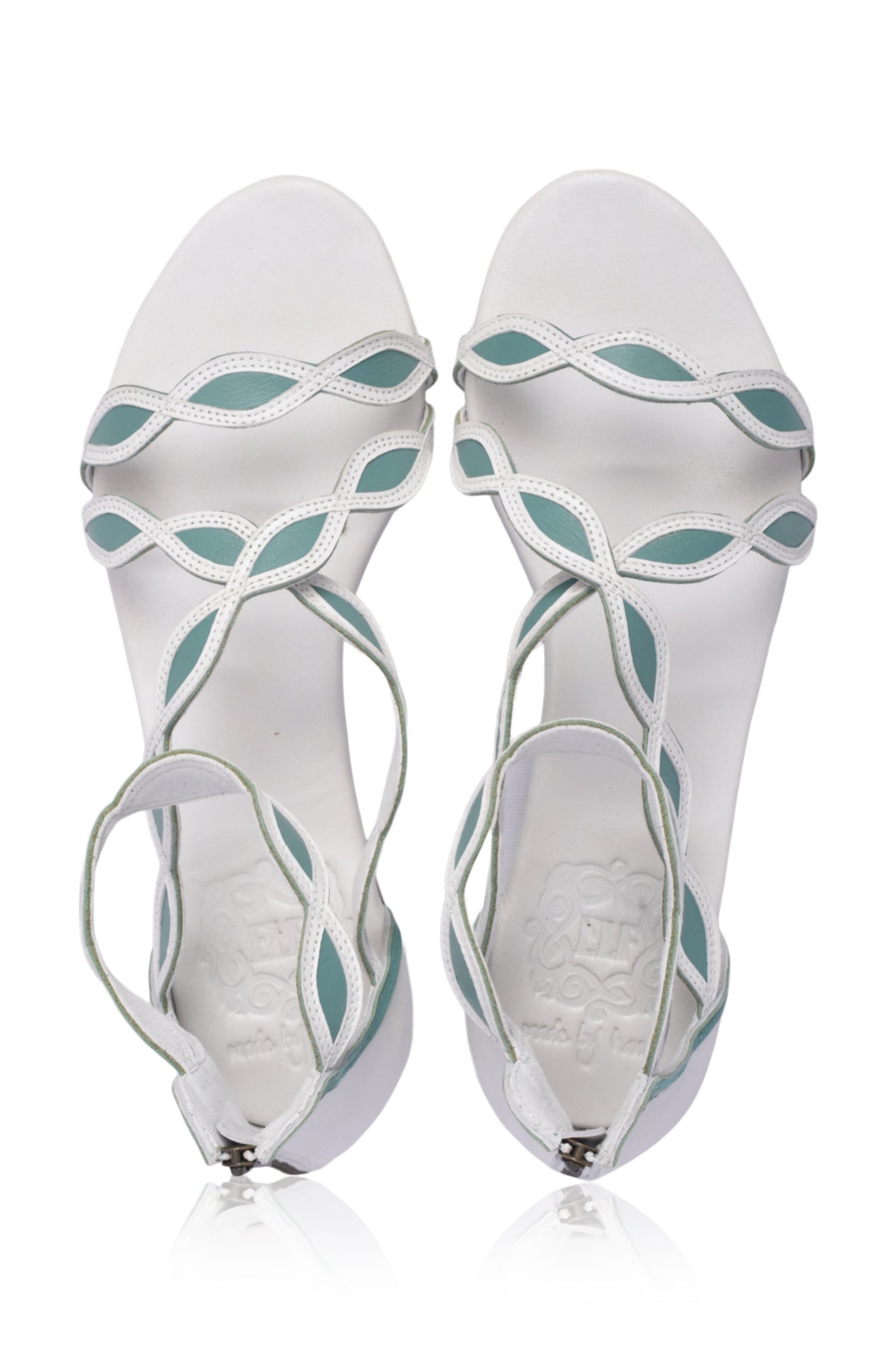 A pair of Blossom Leather Sandals featuring a floral design, crafted from high-quality leather with an adjustable ankle buckle and back zipper.