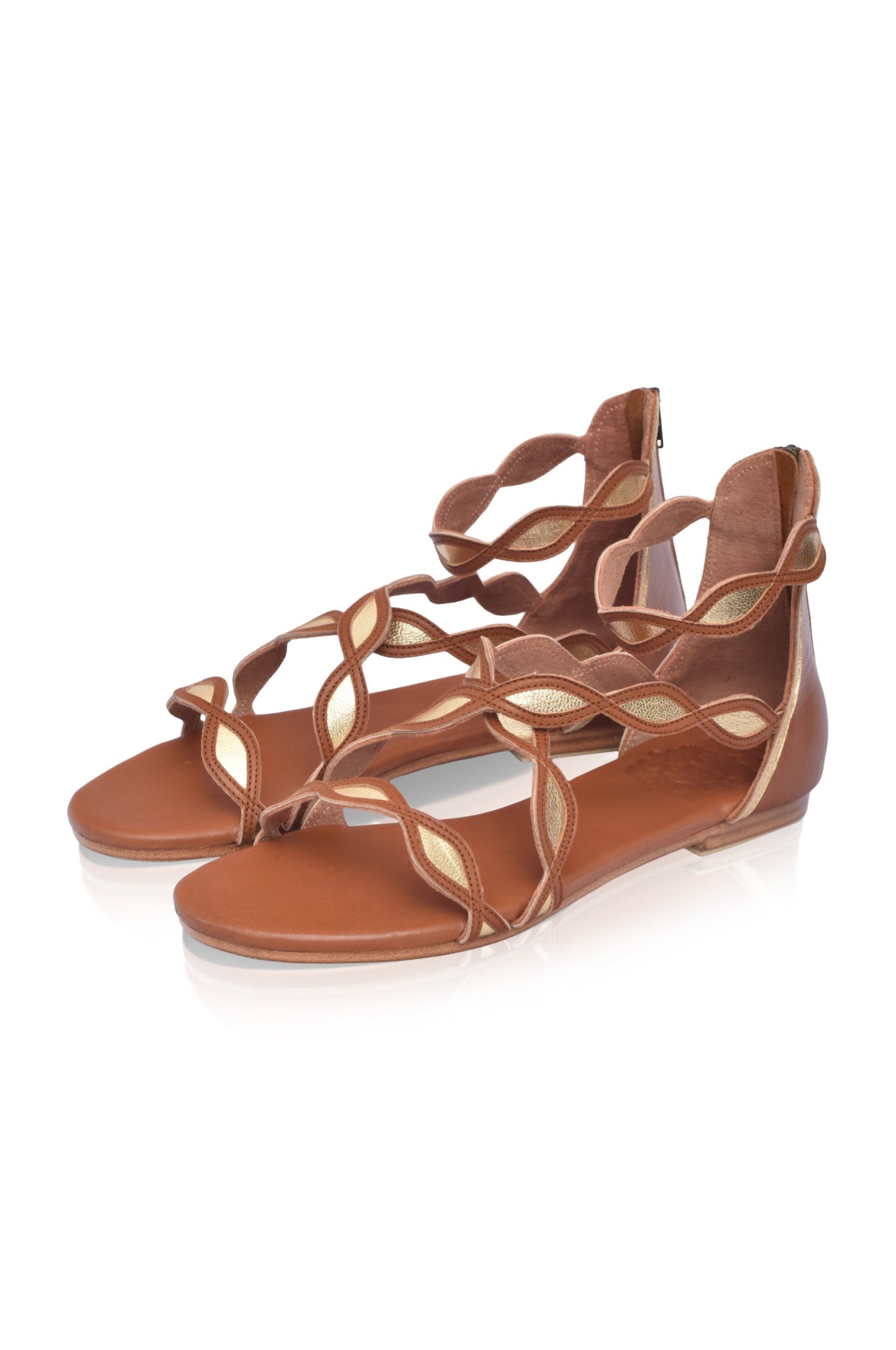 A pair of Blossom Leather Sandals featuring a floral design, crafted from high-quality leather with an adjustable ankle buckle and back zipper.