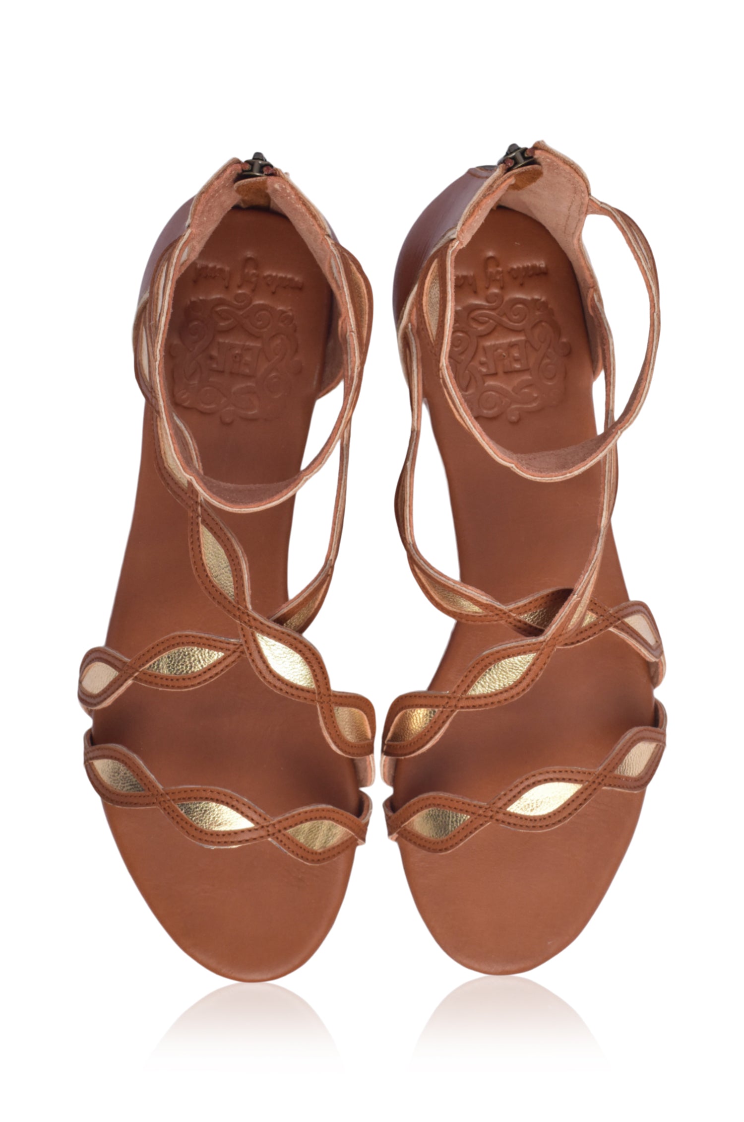 A pair of Blossom Leather Sandals featuring a floral design, crafted from high-quality leather with an adjustable ankle buckle and back zipper.