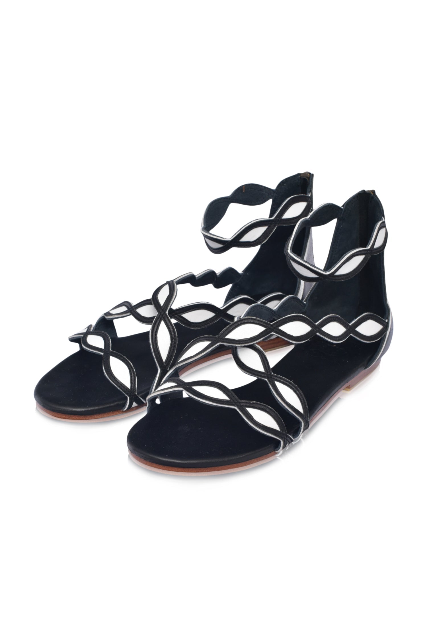 A pair of Blossom Leather Sandals featuring a floral design, crafted from high-quality leather with an adjustable ankle buckle and back zipper.