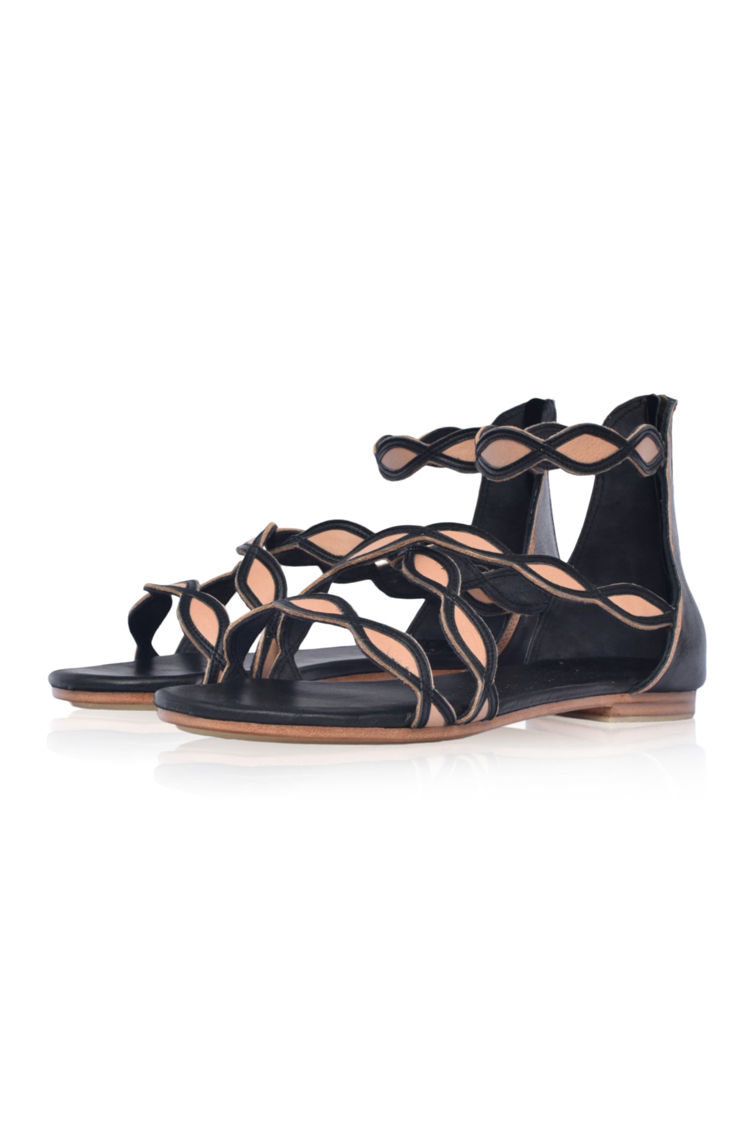 A pair of Blossom Leather Sandals featuring a floral design, handcrafted from high-quality leather with an adjustable ankle buckle and back zipper.