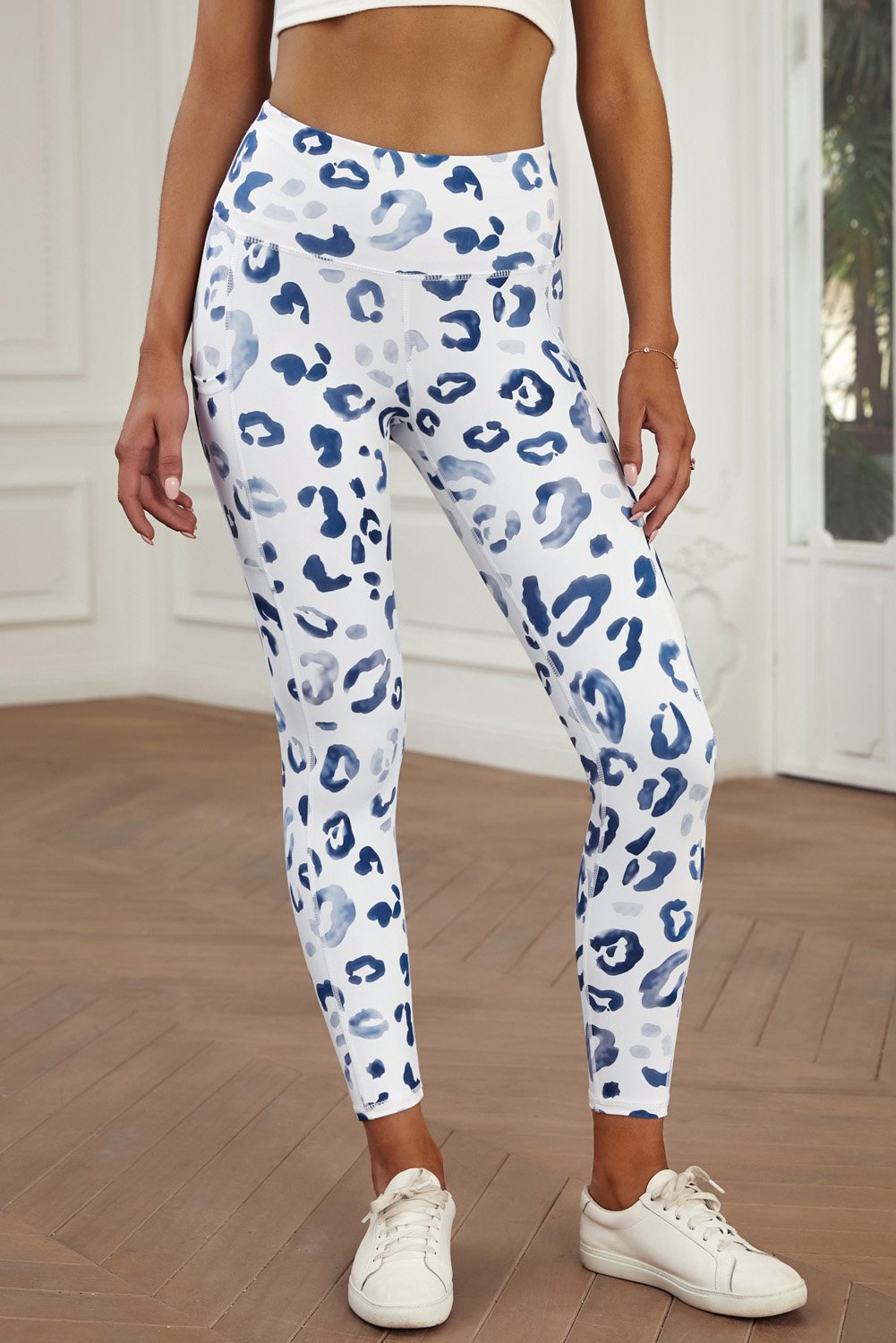 Blue leopard print athletic leggings with side pockets, perfect for workouts and casual wear.