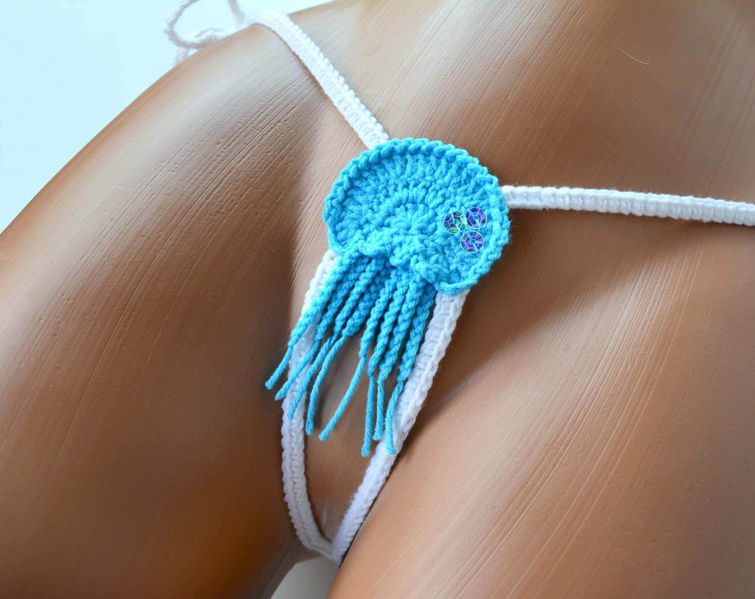 Handmade blue micro G string bikini bottom showcasing minimal coverage and stylish design, perfect for beach and pool activities.