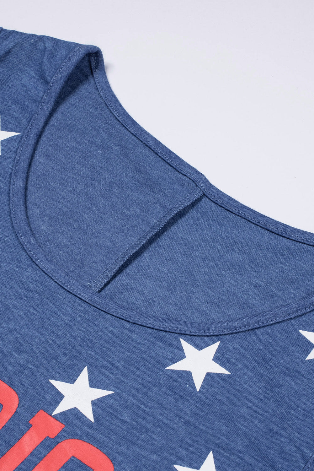 Blue star-patterned scoop neck shirt.