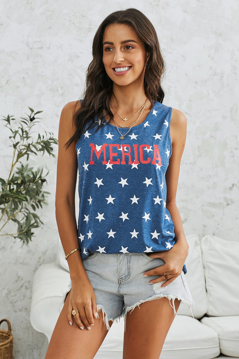 Woman wearing star-patterned "MERICA" tank top.