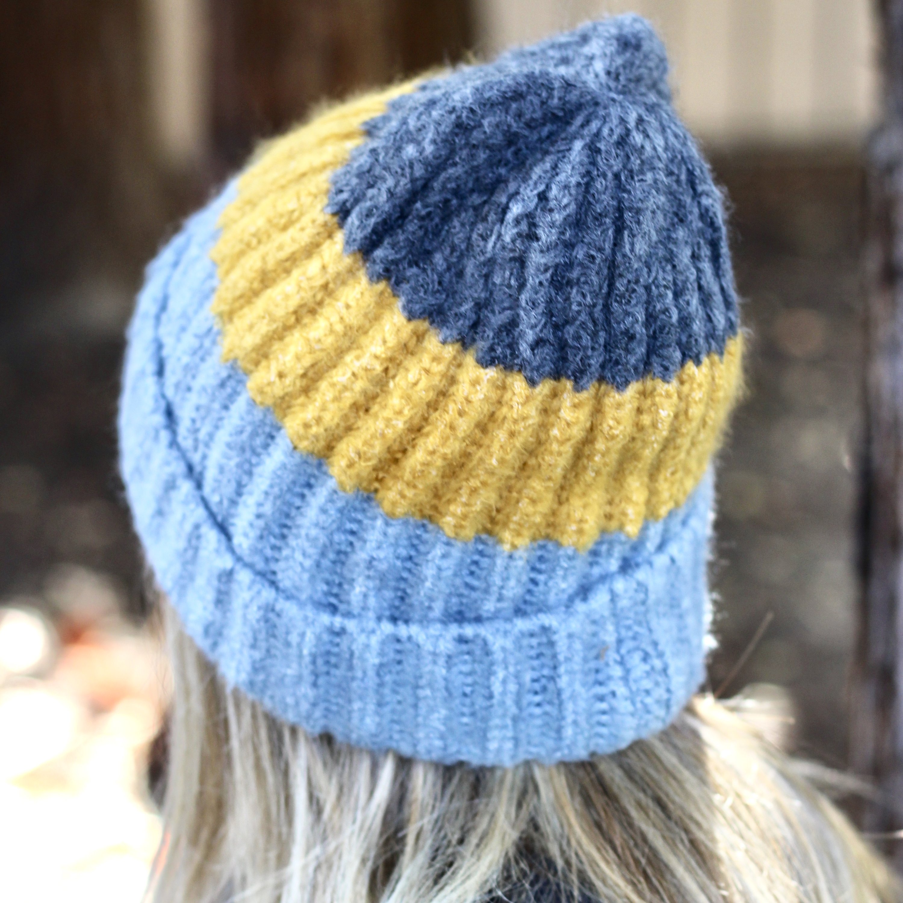 Blue and mustard colorblock beanie with a slouchy design, perfect for winter wear.