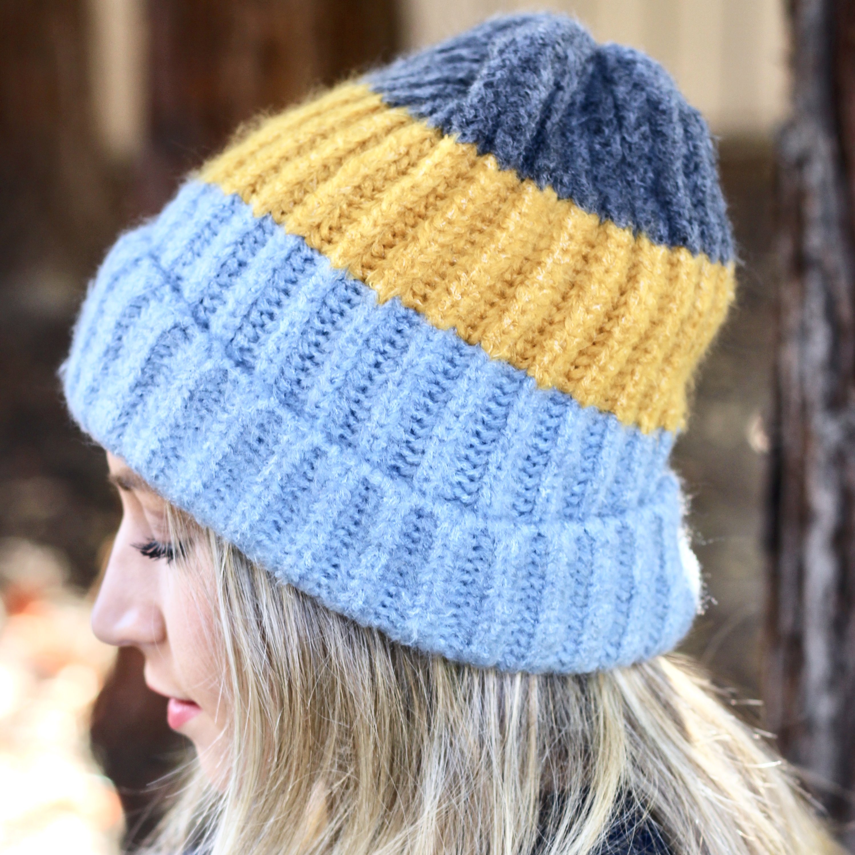 Blue and mustard colorblock beanie with a slouchy design, perfect for winter wear.