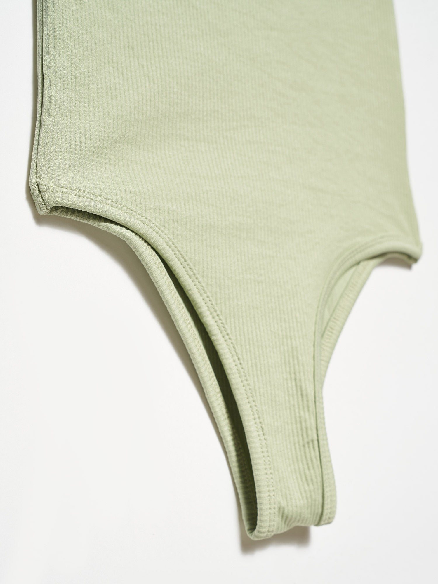 A stylish bodysuit made from a blend of polyester and elastane, showcasing its sleek design and comfortable fit.