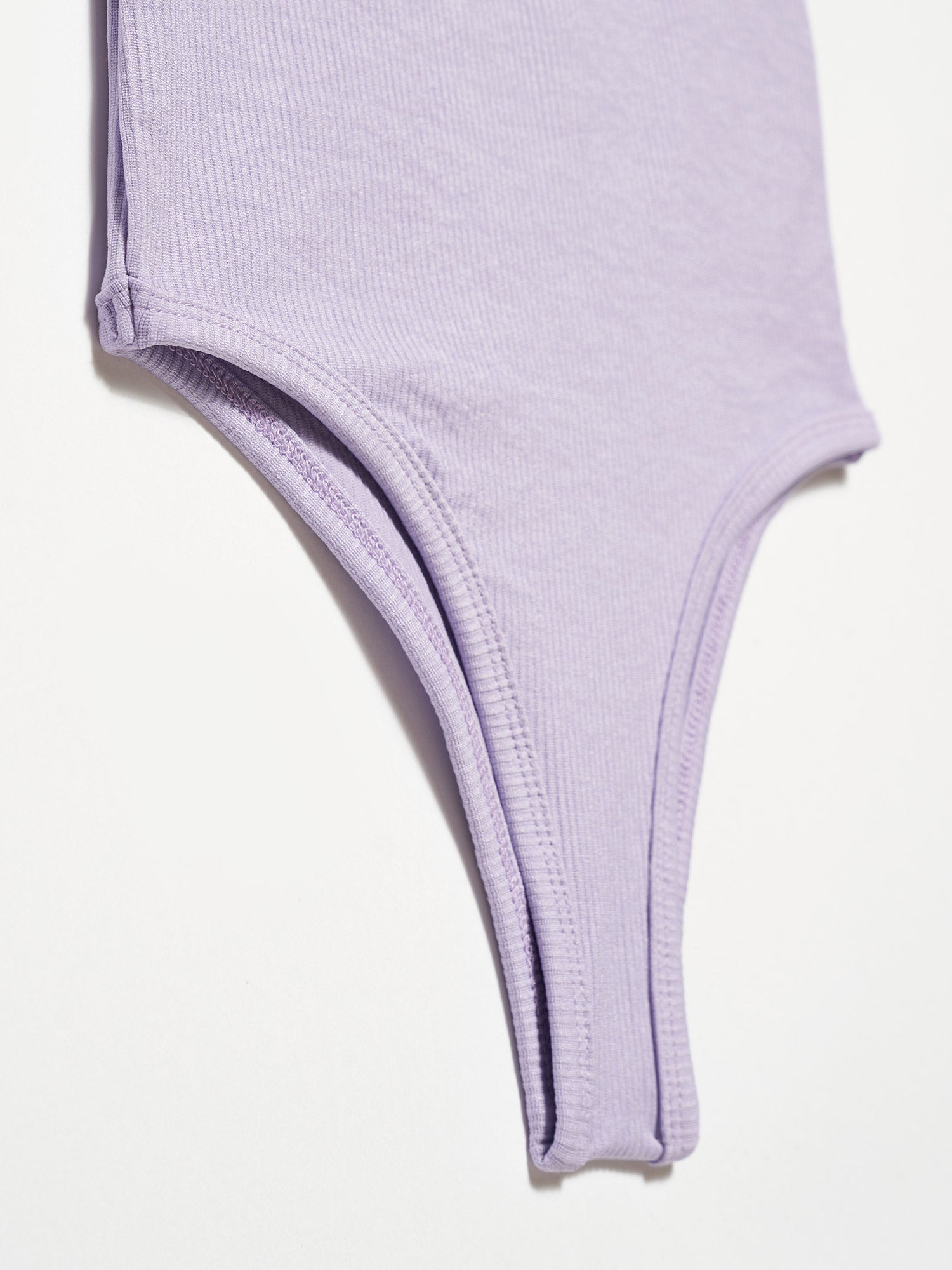 A stylish bodysuit made from a blend of polyester and elastane, showcasing its sleek design and comfortable fit.