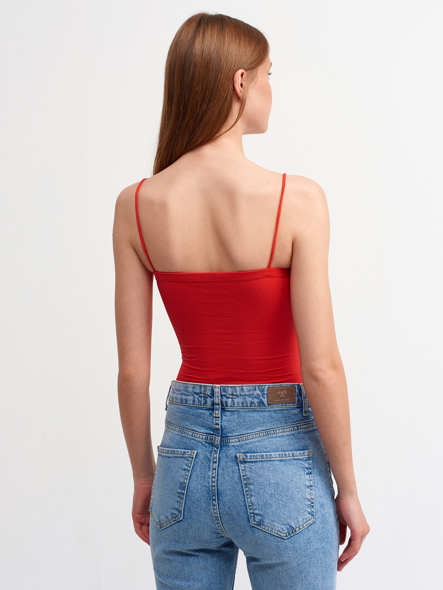 A stylish bodysuit made from a blend of polyester and elastane, showcasing its sleek design and comfortable fit.