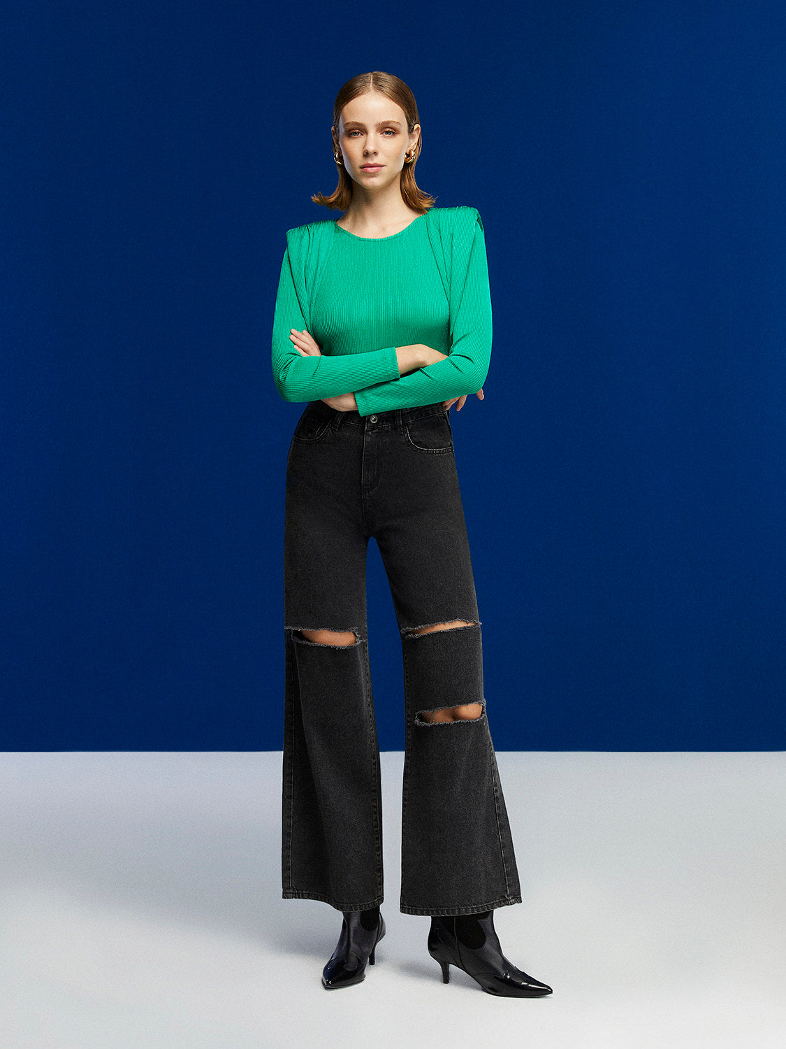 Chic crew-neck bodysuit with long sleeves and stylish shoulder pads, featuring a snap bottom closure.