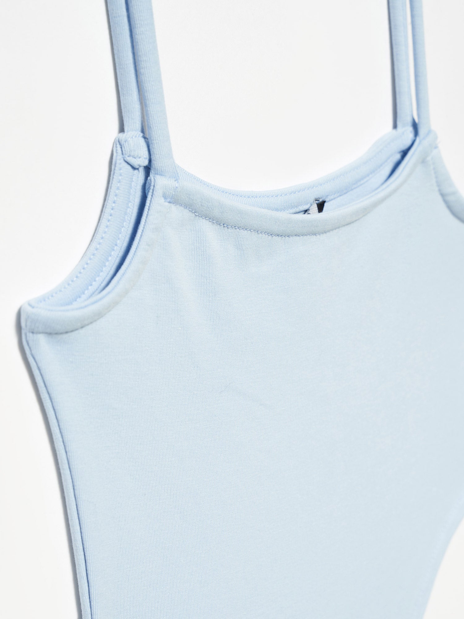 A stylish bodysuit made from 98% cotton and 2% elastane, showcasing its soft fabric and comfortable fit.