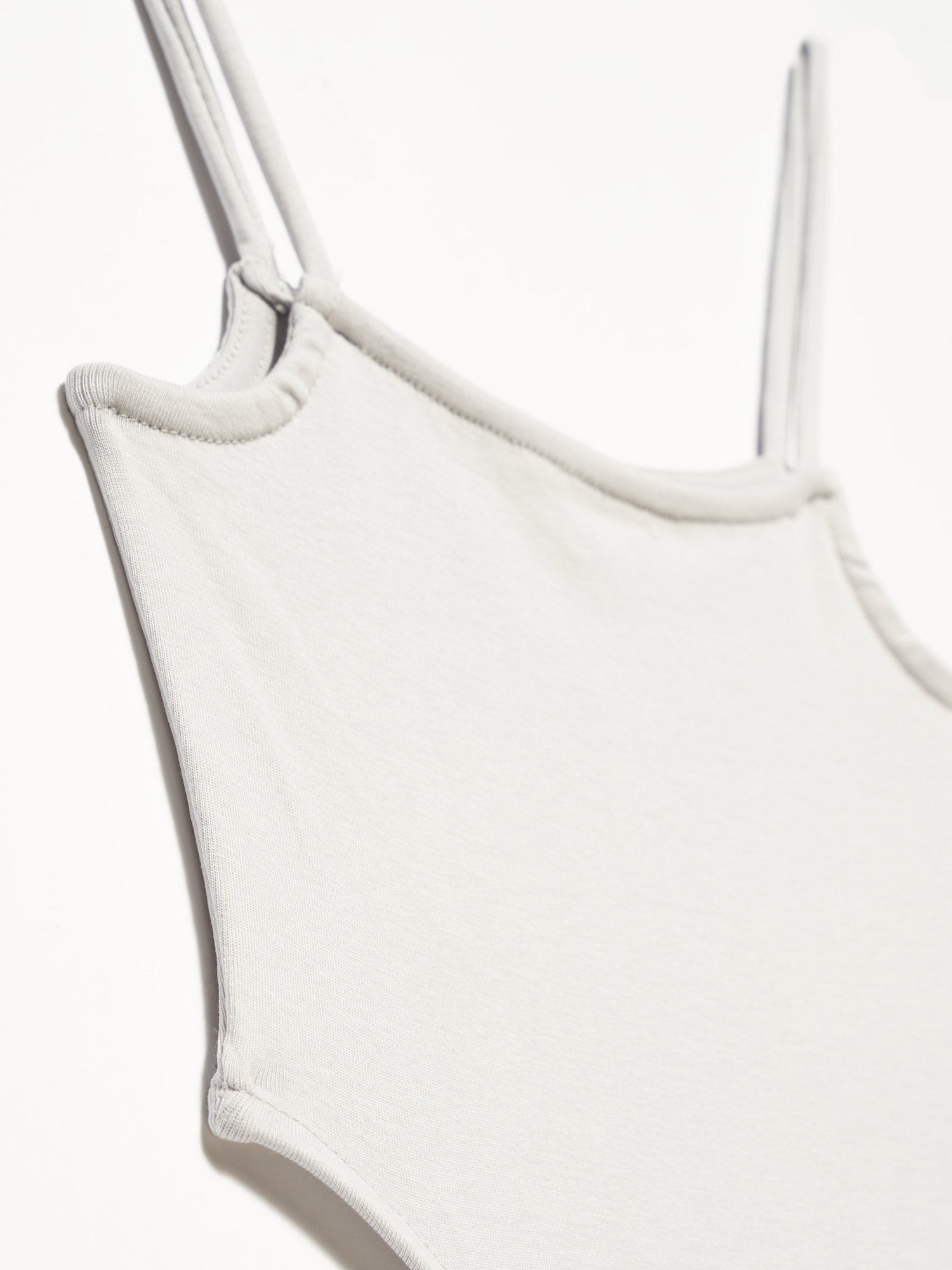 A stylish bodysuit made from 98% cotton and 2% elastane, showcasing its soft fabric and comfortable fit.