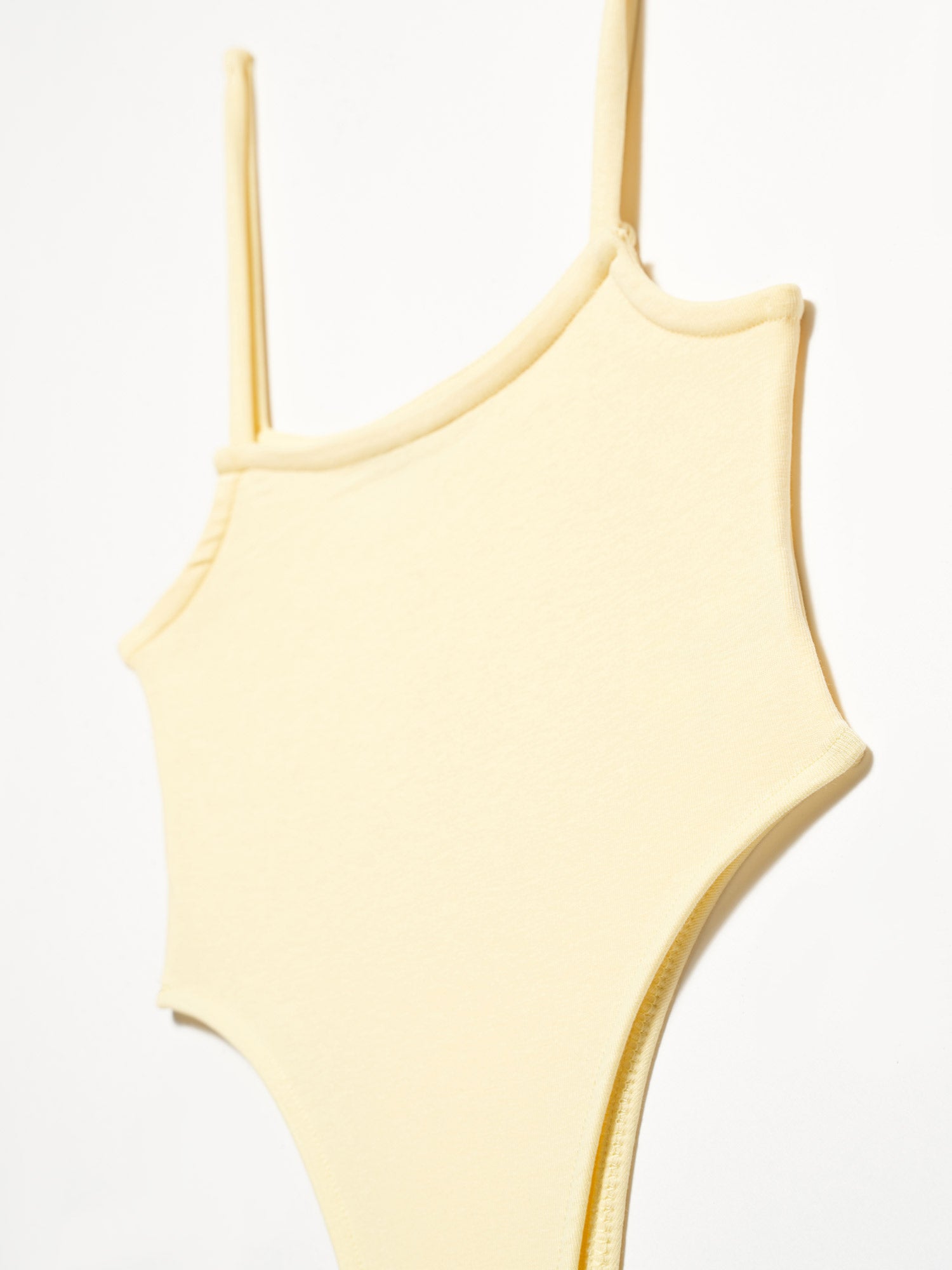 A stylish bodysuit made from 98% cotton and 2% elastane, showcasing its soft fabric and comfortable fit.