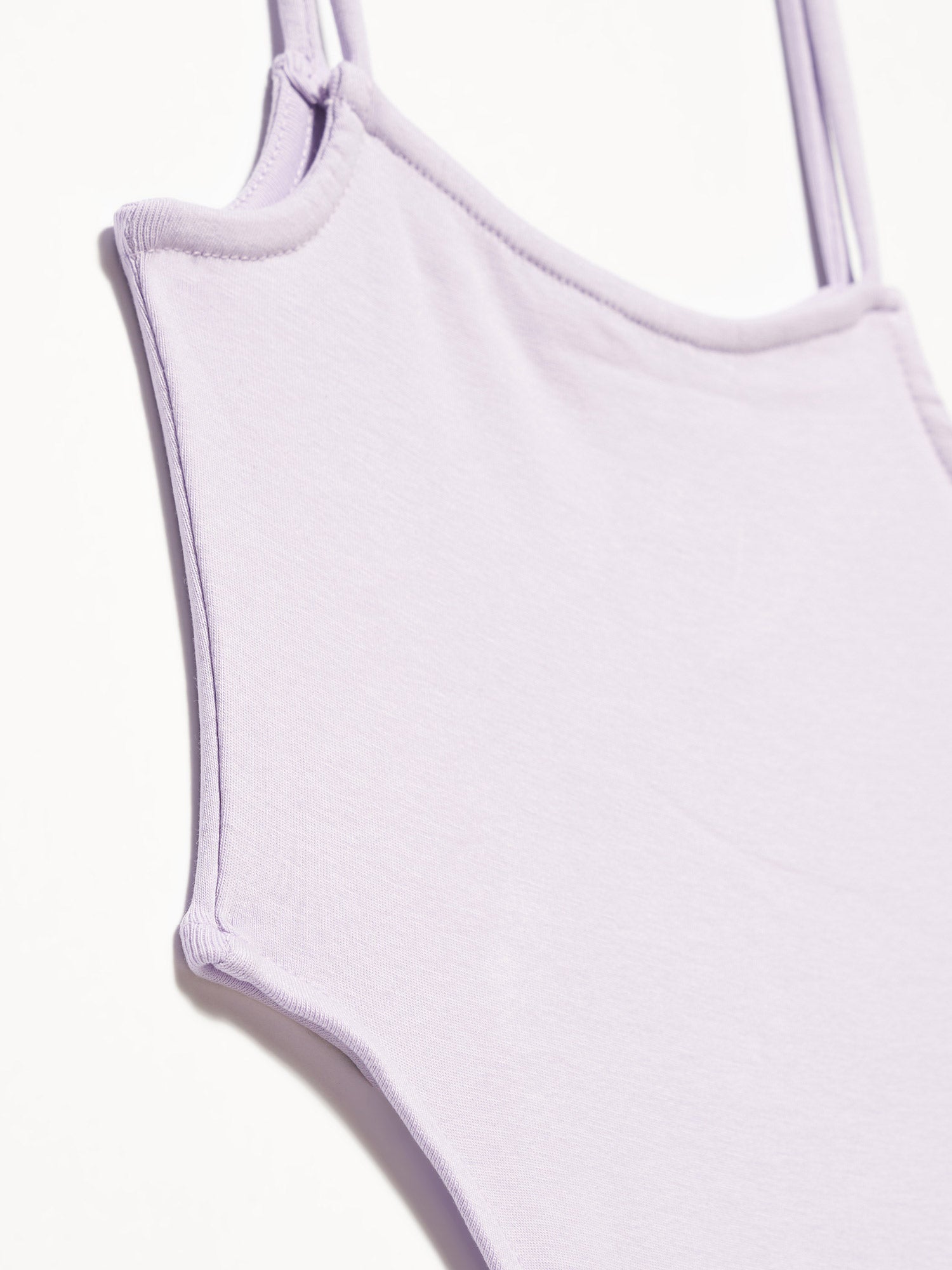 A stylish bodysuit made from 98% cotton and 2% elastane, showcasing its soft fabric and comfortable fit.