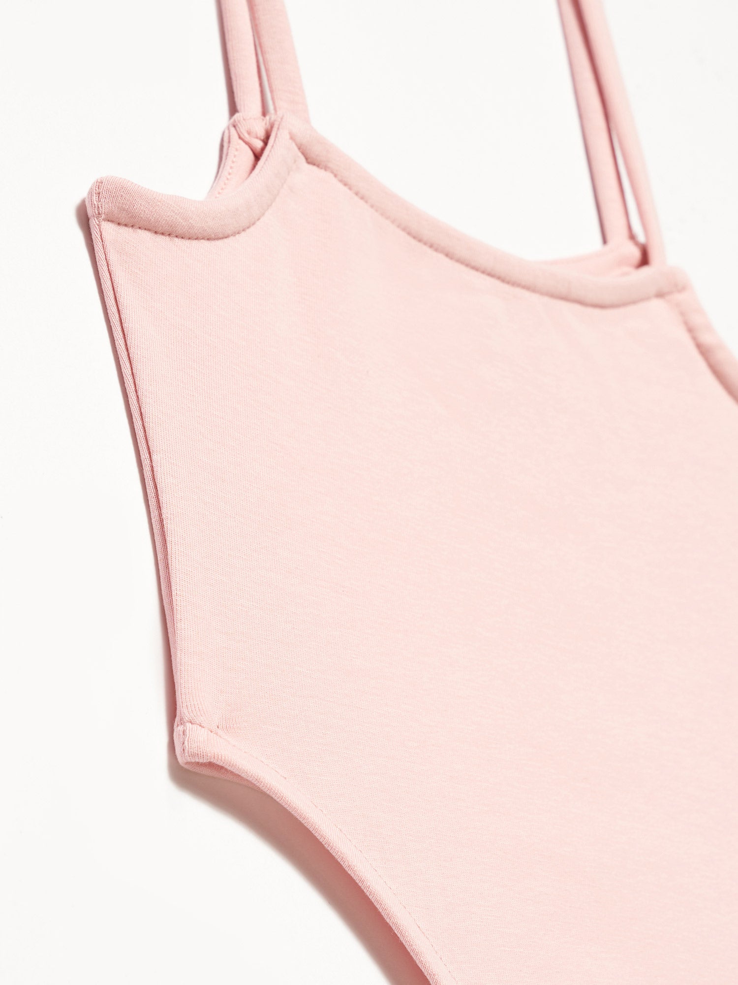 A stylish bodysuit made from 98% cotton and 2% elastane, showcasing its soft fabric and comfortable fit.