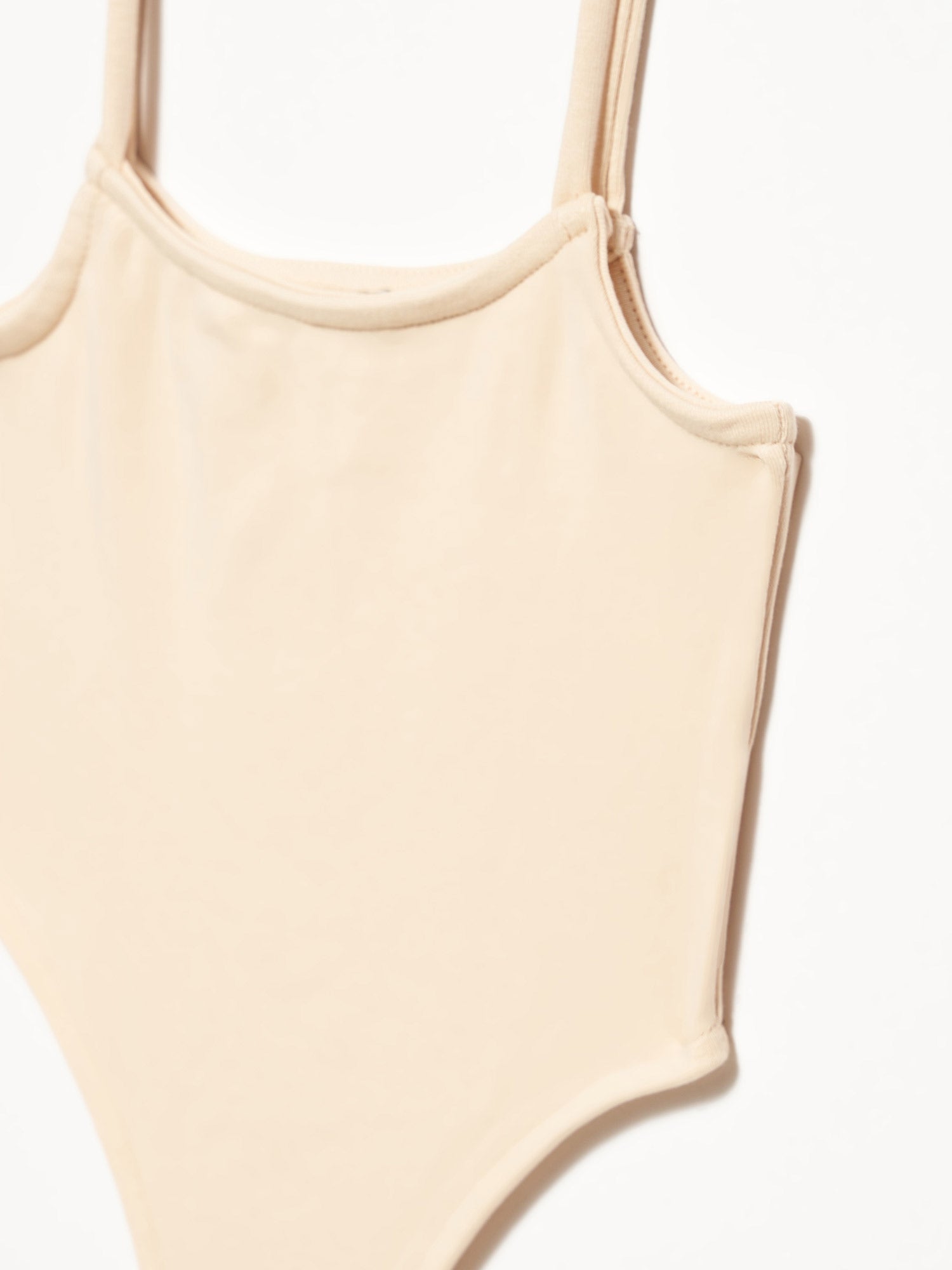 A stylish bodysuit made from 98% cotton and 2% elastane, showcasing its soft fabric and comfortable fit.