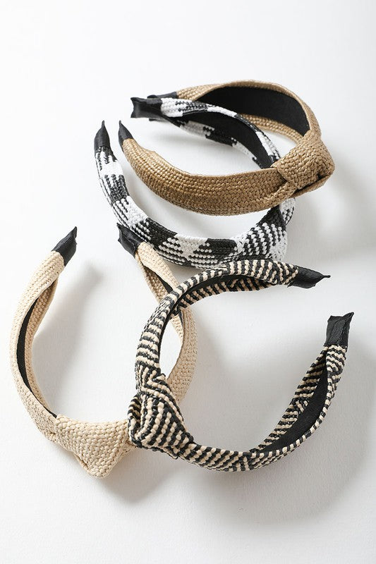 A stylish Bohemian Straw Rattan Knotted Headband featuring a unique knotted design, made from natural straw rattan, perfect for summer outfits.