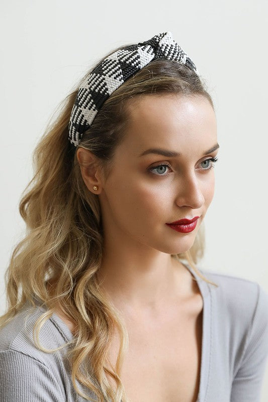 A stylish Bohemian Straw Rattan Knotted Headband featuring a unique knotted design, made from natural straw rattan, perfect for summer outfits.