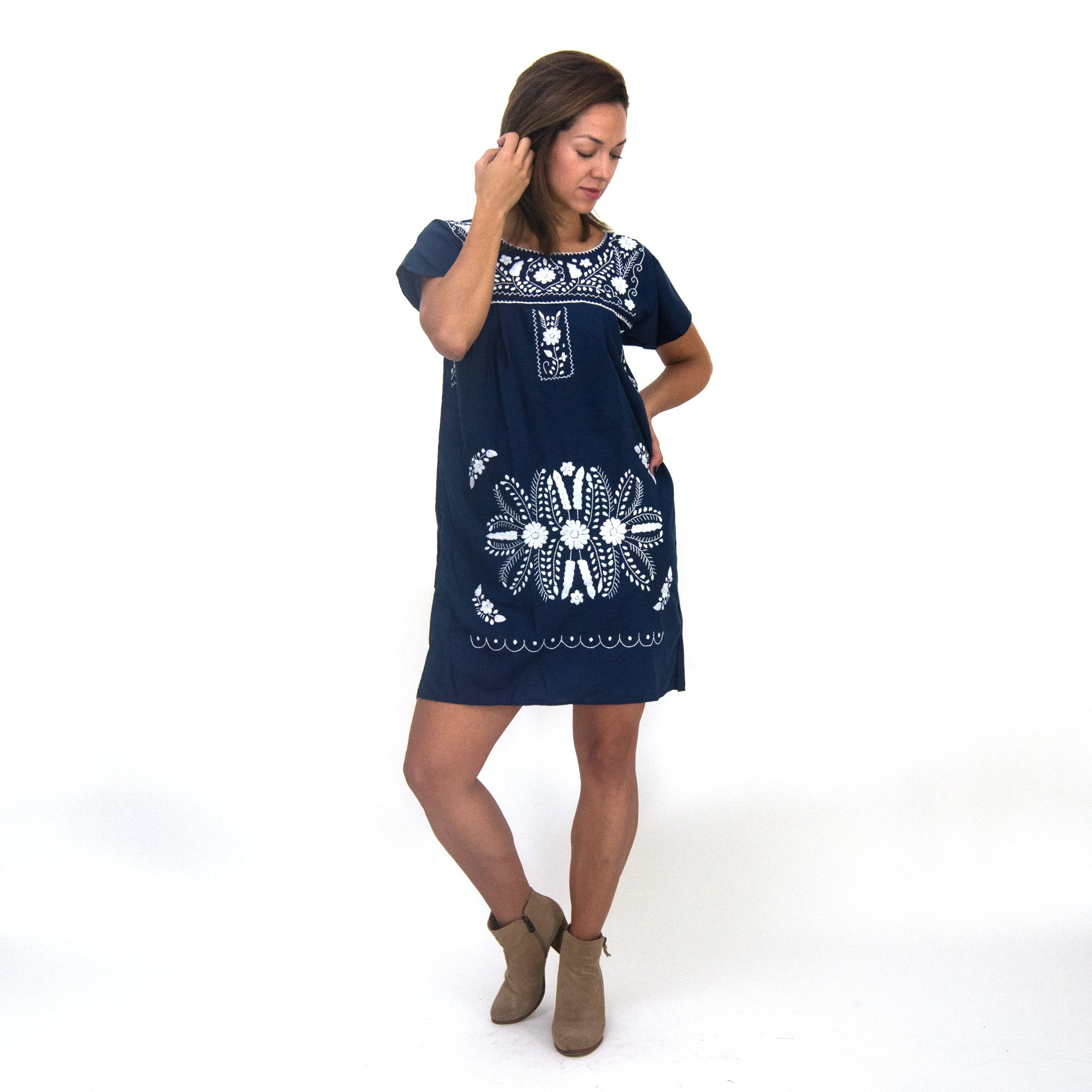 A beautiful navy blue dress adorned with white flowers, showcasing intricate hand embroidery, perfect for bohemian style.